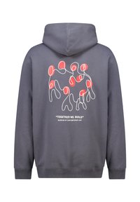 Grijze hoodie met een grafisch ontwerp van met elkaar verbonden figuren in wit en rood. De tekst bevat "SAMEN BOUWEN WE" en "MUSEUM VOOR CONTEMPORARY ART."