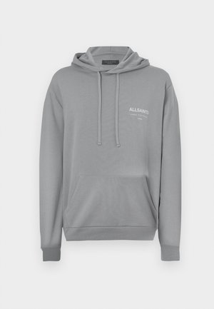 Pilkas medvilnės džemperis su priekiniais kišenėmis, raišteliais ir išsiuvinėtu logotipu ant krūtinės. Ilgos rankovės su perliniu apdailu.