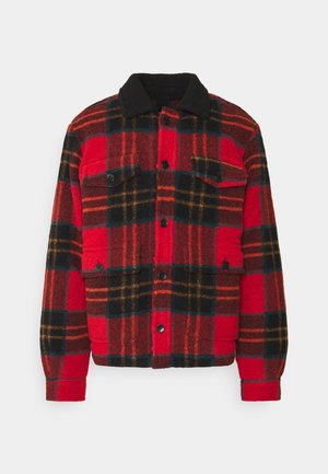 Red and black plaid jacket made from wool, featuring a snap-button closure, two chest pockets, and a black collar. Soft texture.