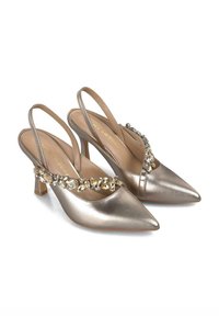 Talons slingback dorés métalliques avec bouts pointus, petits talons carrés, et un accent bijou sur l'arche. Texture lisse et design élégant.