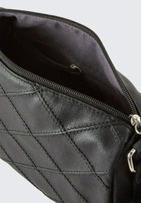 Schwarze, gesteppte Lederhandtasche mit einem Reißverschluss. Glatte Textur und sichtbare Innenfächer, ausgestattet mit silbernen Hardware-Details.