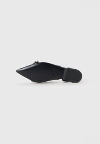 Black pointed-toe shoe with a smooth texture, featuring a silver accent and a low heel. The design is sleek with a minimalistic style.