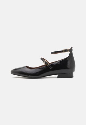Black patent leather Mary Jane shoes with a pointed toe, ankle strap, and small block heel. Features gold-tone hardware accents.