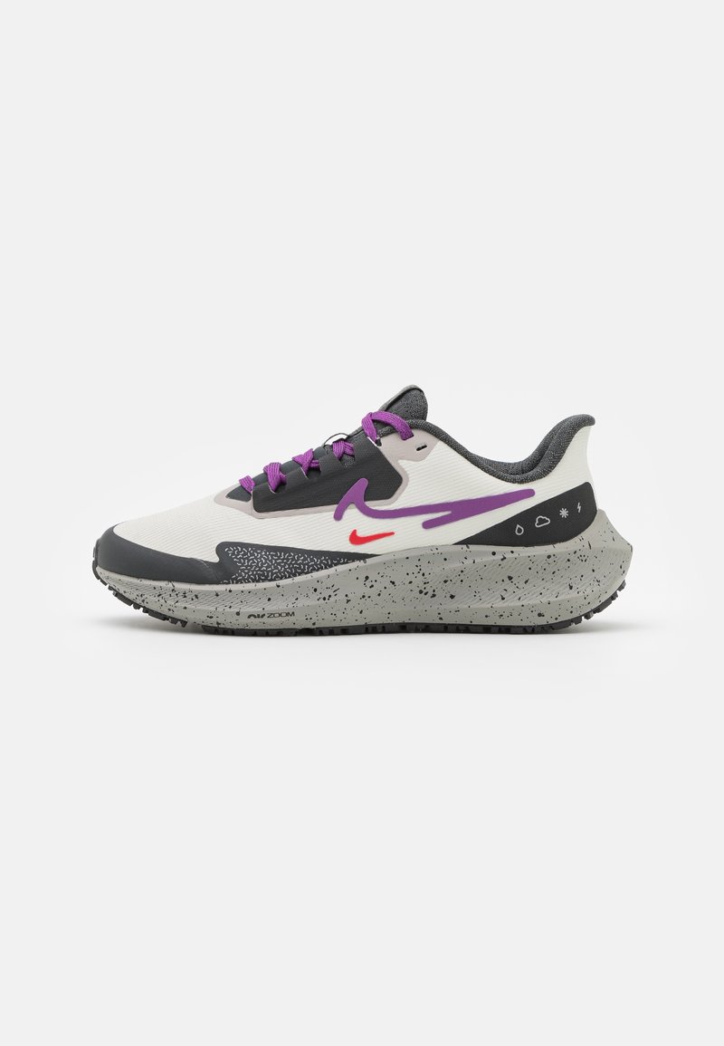 Men's running shoe featuring a white mesh upper, grey and black accents, purple laces, and a speckled grey sole with a textured design.