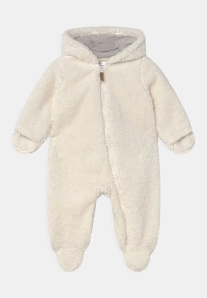 Monos de forro polar color crema con cremallera completa, capucha y forro a rayas. Presenta pies cerrados y puños redondeados para mayor calidez.