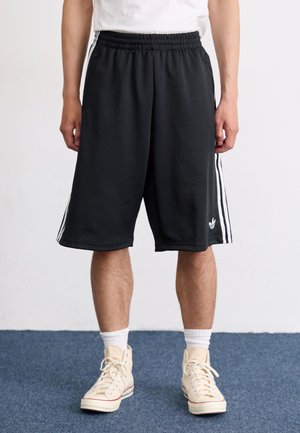 OVERSIZED - Tracksuit bottoms - black