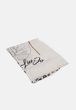Écharpe en tissu blanc pliée avec texte en cursive noire "Liu Jo,", motifs floraux et abstraits, et bords à franges sur un fond uni.