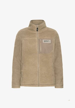 Veste en polaire beige avec col montant, fermeture éclair sur le devant, deux poches latérales avec boutons et poche poitrine zippée avec l'étiquette "Conçue avec Dévouement."