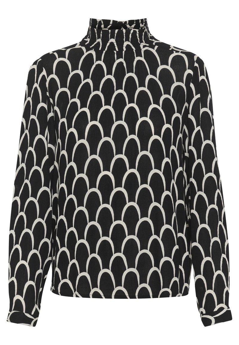 Blusa a maniche lunghe bianca e nera con collo alto, caratterizzata da un motivo a scallop ripetuto e un tessuto morbido e testurizzato.