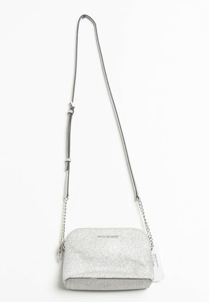 Silver glitter crossbody bag with a curved shape, chain and strap handle, and a smooth, shiny texture. Features subtle logo accent.