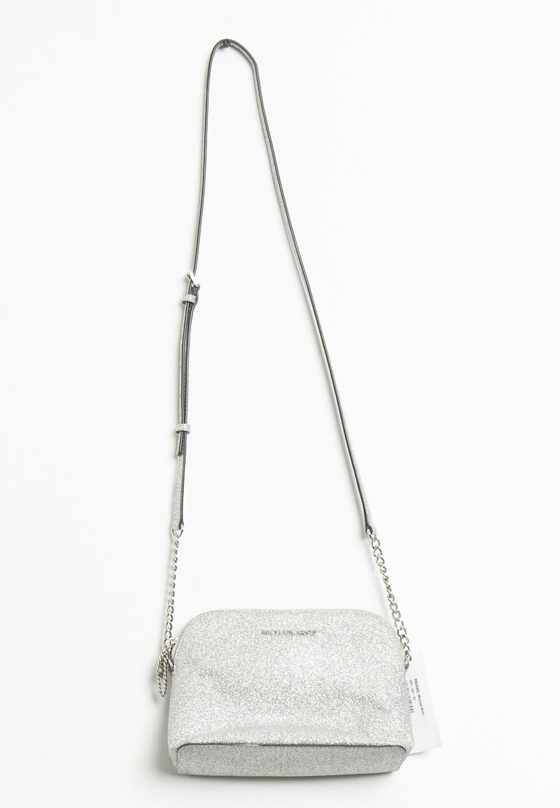 Silver glitter crossbody bag with a curved shape, chain and strap handle, and a smooth, shiny texture. Features subtle logo accent.