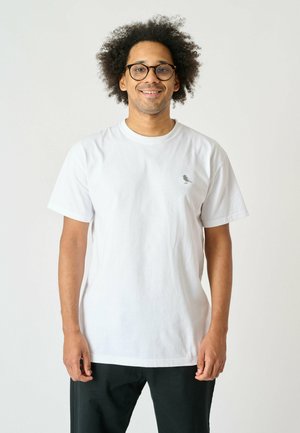 White cotton t-shirt featuring a round neckline and short sleeves, with a subtle gray logo on the left side of the chest.