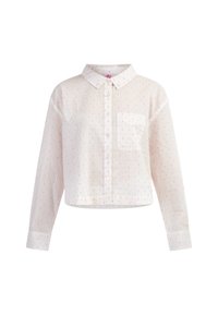 Camicia bianca cropped con maniche lunghe, chiusura con bottoni davanti, colletto e taschino sul petto. Presenta piccoli motivi a pois rosa e arancione in tutto il capo.