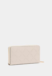 Beige textured wallet with embossed logo pattern, gold zipper hardware, and slim rectangular shape. Smooth leather finish.