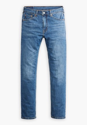 Světle modré džíny z denimu se střihovým středním nohavicím, pěti kapsami a klasickým zapínáním na knoflíky a zip. Jemně opotřebená textura.