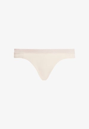 String beige chiaro realizzato in tessuto morbido, con una vita accentuata in pizzo. Design semplice con copertura minimale e finitura senza cuciture.