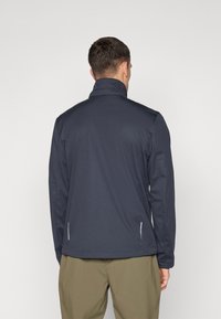 Navy blue lightweight jacket with a high collar and side zip pockets. Features a smooth texture and a tailored fit.