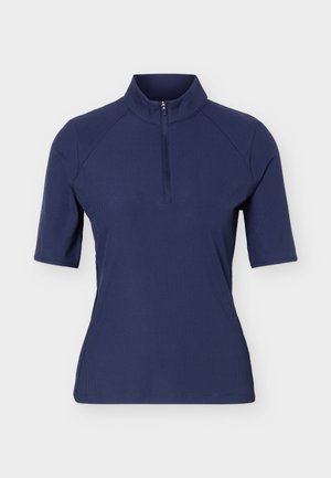 Námořnicky modrý top s krátkým rukávem, čtvrtinovým zipem vpředu a stojáčkovým límcem, vyrobený z žebrované látky.