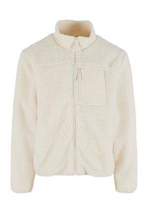Jachetă din fleece de culoare crem deschis cu guler înalt și închidere cu fermoar. Prezintă un mic buzunar cu fermoar pe pieptul stâng și un material texturat.