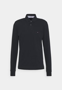 Long-sleeve navy polo shirt made of cotton, with a buttoned collar and a small logo on the chest. Features a striped inner collar.