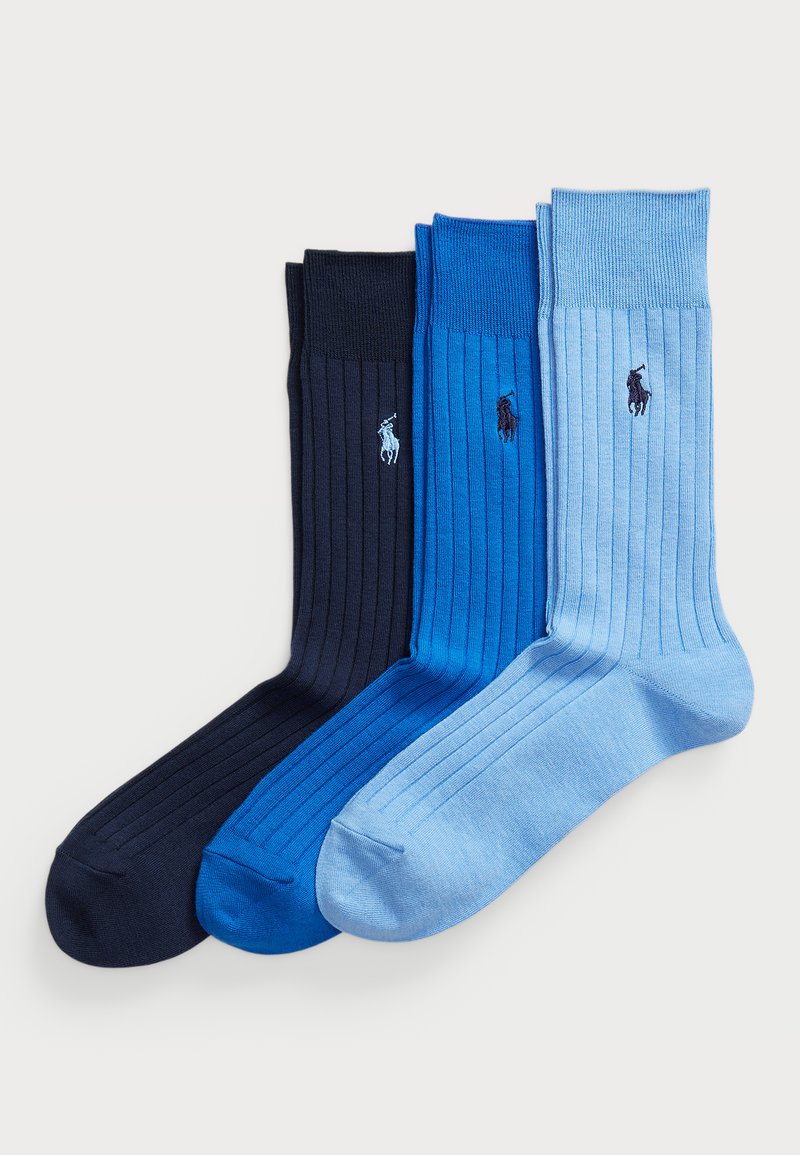 Three pairs of ribbed socks in dark navy, royal blue, and light blue, featuring small embroidered logos on each sock.