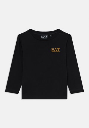 Black long-sleeve shirt with round neckline and small yellow "EA7 Emporio Armani" logo on the upper left chest.