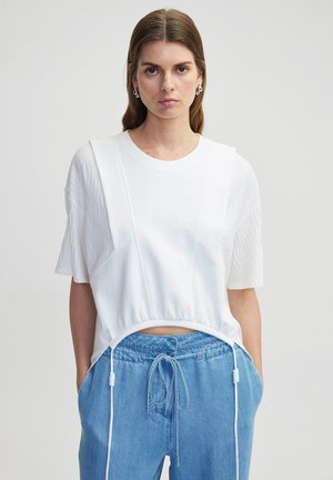 T-shirt court blanc avec des manches oversized texturées et un ourlet à cordon de serrage. Assorti à un pantalon bleu clair à cordon de serrage. Tissu lisse.