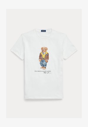 White cotton T-shirt featuring a graphic of a dressed cartoon bear. Notable details include a brown jacket, yellow hoodie, and blue jeans.