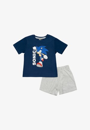 Camicia blu navy a maniche corte con il personaggio di Sonic che corre e la scritta "SONIC", abbinata a pantaloncini grigio chiaro con vita elasticizzata.