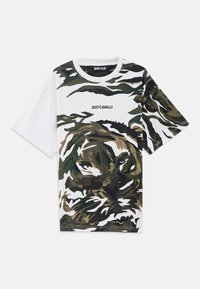 Short-sleeve white t-shirt featuring a green and brown camouflage tiger print, with "JUST CAVALLI" text in black on the chest.