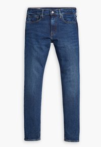 Jean slim en denim bleu foncé avec bouton sur le devant, fermeture éclair et design à cinq poches, présenté sur fond blanc.