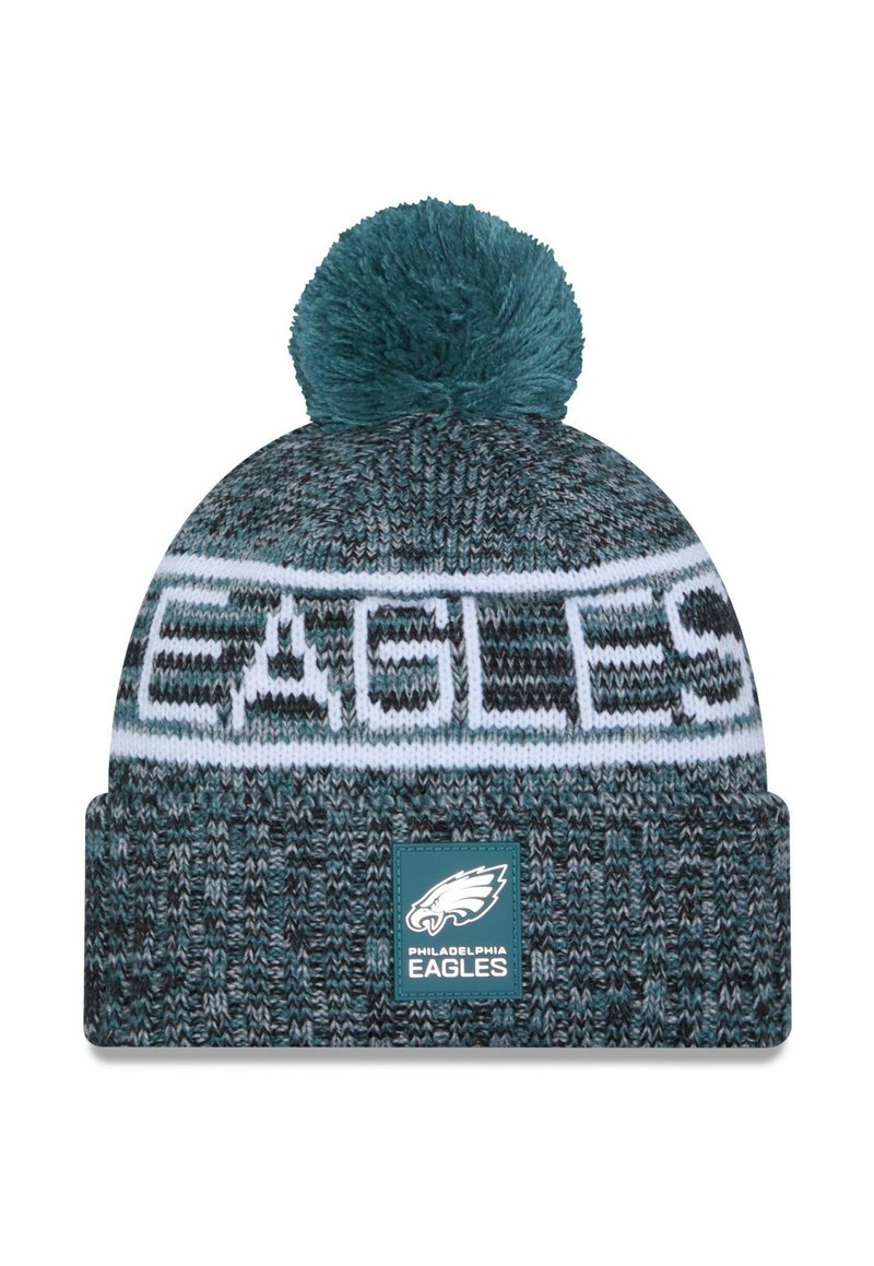 Knit beanie in teal and gray with a white band reading "EAGLES." Features a pom-pom on top and a logo patch at the front.