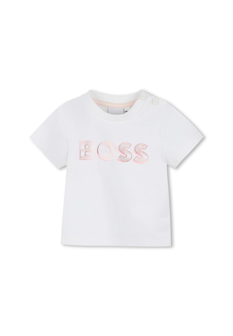 T-shirt blanc en coton avec le mot "BOSS" brodé en rose. Comprend deux boutons-pression sur l'épaule pour un enfilage facile.