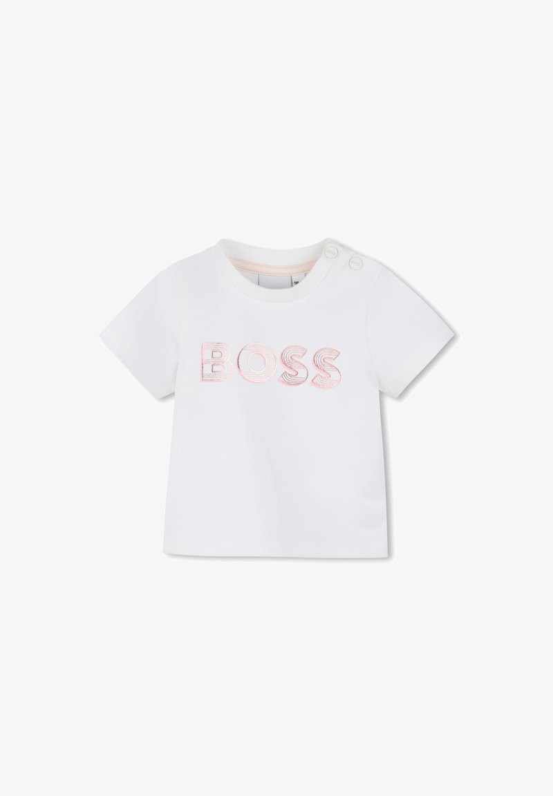 T-shirt blanc en coton avec le mot "BOSS" brodé en rose. Comprend deux boutons-pression sur l'épaule pour un enfilage facile.