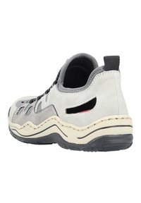 Gray and beige athletic shoe with suede and mesh materials, round toe, stitched sole, and cut-out details on the heel for breathability.