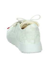 White casual shoe with textured upper, slip-on design, and lace tie. Features a white rubber sole and a small silver zipper accent.