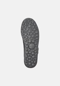 Black rubber shoe sole with a textured pattern of round bubbles, featuring a circular logo and size mark, designed for traction.