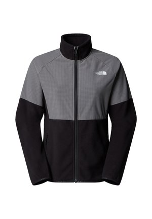 Chaqueta de forro polar que presenta una sección superior gris con textura de cuadrícula y una sección inferior negra. Cierre frontal de cremallera completa con cuello alzado y detalle del logo.