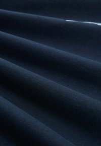 Navy blue fabric with a smooth texture, featuring subtle folds and a slight sheen, showcasing fine, even weave and minimal pattern.