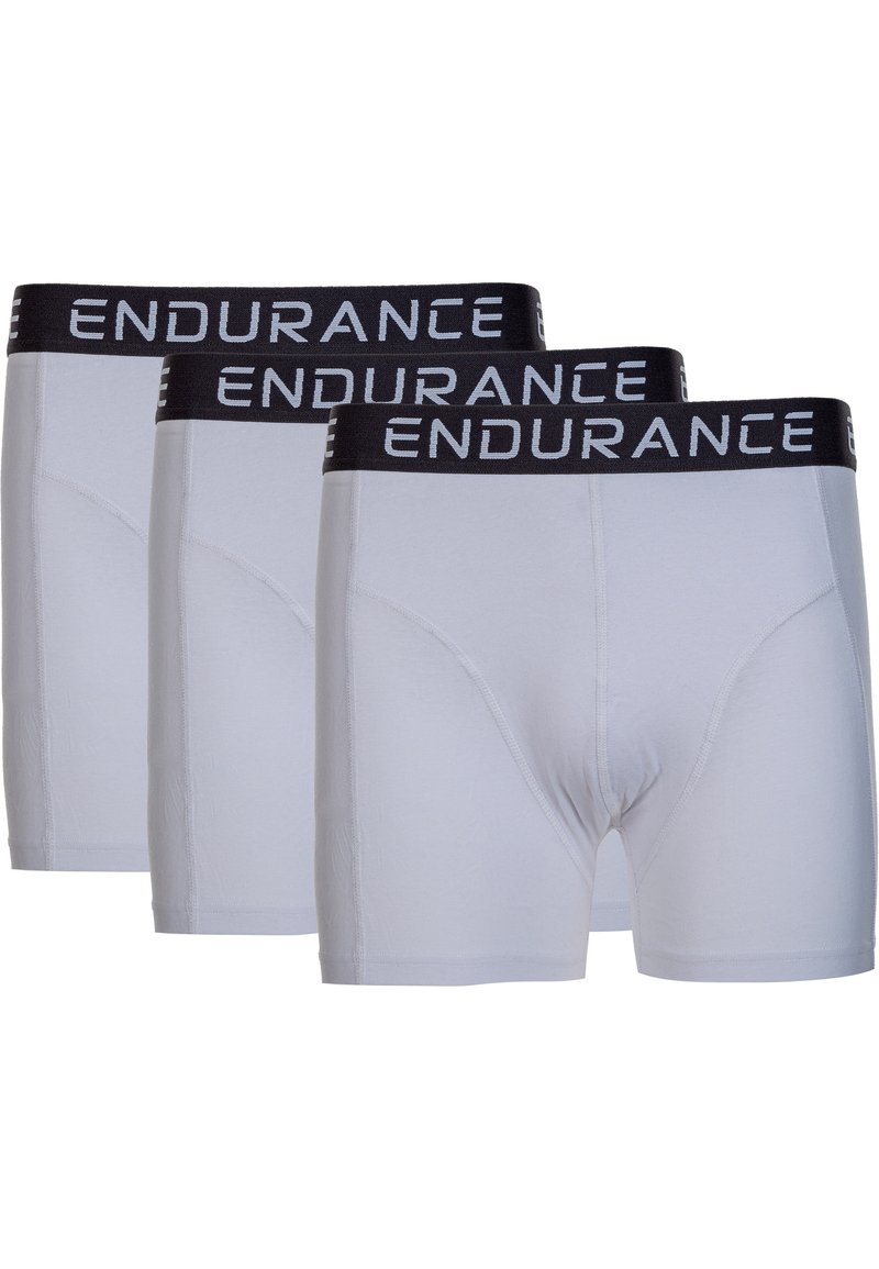 Tre par vita kalsonger med svart elastiskt midjeband där ordet "ENDURANCE" är tryckt i vitt. Slät textur och åtsittande design.