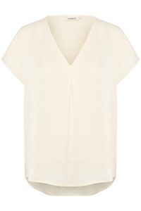 Short-sleeve, V-neck blouse in light cream, made of soft, flowing fabric with a subtle texture and a slight high-low hem design.