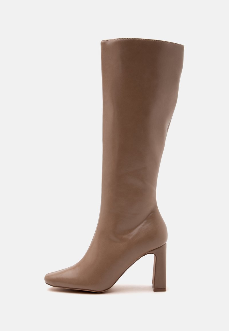 Botte en cuir marron mi-mollet avec bout pointu et talon haut épais, vue de profil sur fond blanc.