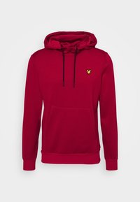 Roter Hoodie mit Kängurutasche, Kordelzügen und einem kleinen gelben gestickten Logo auf der Brust. Hergestellt aus weichem Stoff mit gerippten Bündchen.