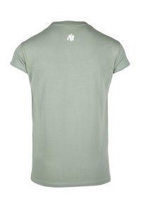 Lichtgroene katoenen t-shirt met korte mouwen, ronde halslijn en een kleine witte gorilla afdruk op de bovenrug. Glad oppervlak.