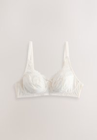 White lace bra with thin adjustable straps and soft cup design, laid flat on a light background.