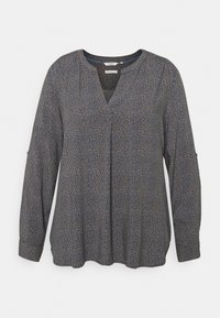 Blouse marine à manches longues avec motif beige tacheté, fente en V et détails de patte boutonnée sur les manches.