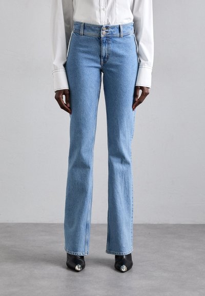 Light blue denim flared jeans with a high waist, featuring a button closure, side pockets, and slight distressing at the hem.