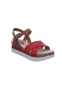Red leather sandals with brown leather accents, cross straps, and a cork footbed. Features a white outsole with textured tread.