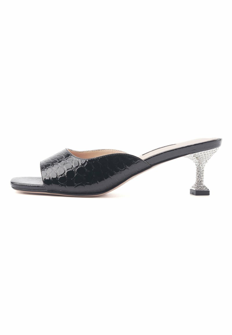 Black open-toe mules with a glossy finish, featuring a unique textured pattern and a sparkling crystal-embellished block heel.