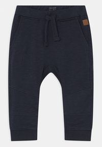 Dunkelblaue Jogginghosen aus weichem Stoff, mit einem elastischen Bund und Zugband, seitlichen Taschen und schmalen Bündchen.